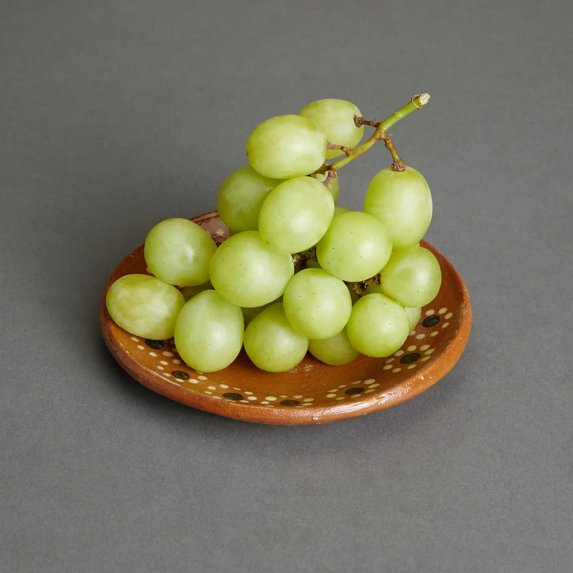 A ceramic bowl of grapes